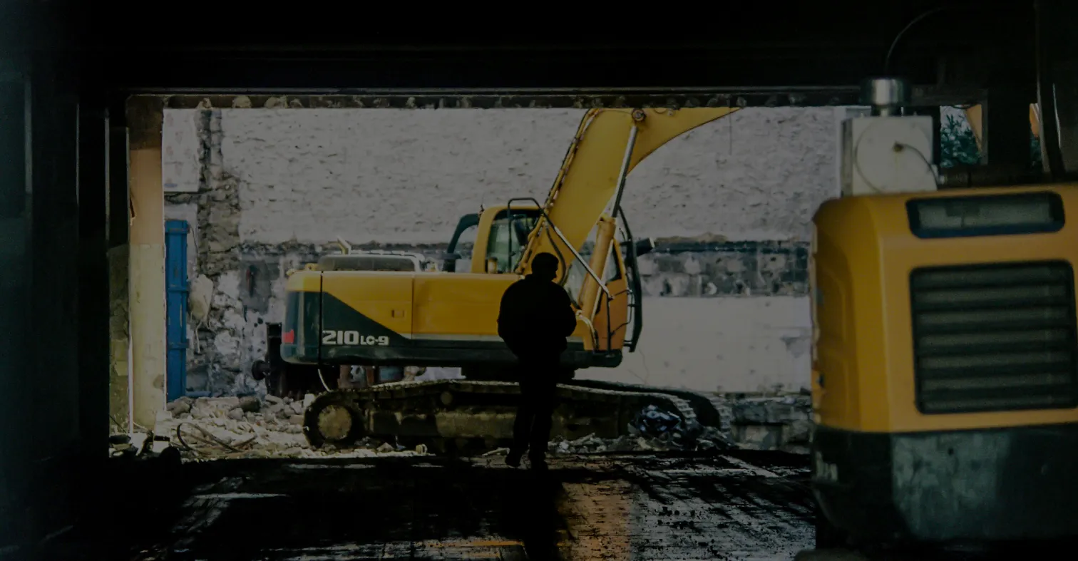 A man infront of crane in worksite
